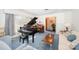 Bright living room featuring a grand piano, large window, and cozy seating area, creating an inviting space at 812 Clinton Ave, Lancaster, SC 29720