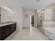 Bathroom with granite countertop vanity, tiled shower with glass door, and soaking tub, a relaxing retreat at 8614 Goodman Park Ct, Charlotte, NC 28277