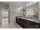 Bright bathroom with granite counters, dual sinks, and a shower over the tub at 8614 Goodman Park Ct, Charlotte, NC 28277