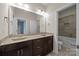 Bathroom with granite countertops and a shower over the tub at 8614 Goodman Park Ct, Charlotte, NC 28277
