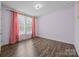 Bedroom with hardwood floors, large windows, and stylish curtains at 8614 Goodman Park Ct, Charlotte, NC 28277