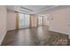Bright bonus room with coffered ceiling, hardwood floors, and large windows, perfect for entertaining guests at 8614 Goodman Park Ct, Charlotte, NC 28277