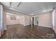 Large bonus room with tray ceiling, hardwood floors, and neutral paint is an inviting flexible space at 8614 Goodman Park Ct, Charlotte, NC 28277