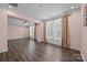Open bonus room featuring hardwood floors, a coffered ceiling, and natural light through large windows at 8614 Goodman Park Ct, Charlotte, NC 28277