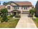Two-story brick home with a well-manicured lawn, two-car garage, and basketball hoop at 8614 Goodman Park Ct, Charlotte, NC 28277