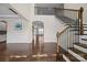 Elegant foyer featuring hardwood floors, a staircase with wood railings, and an open floor plan at 8614 Goodman Park Ct, Charlotte, NC 28277
