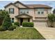 Charming two-story brick home with a well-manicured lawn and a two-car garage at 8614 Goodman Park Ct, Charlotte, NC 28277
