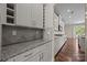 Butlers pantry with granite countertops and wine rack at 8614 Goodman Park Ct, Charlotte, NC 28277
