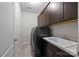 Convenient laundry room featuring cabinetry, utility sink, washer, and dryer hookups at 8614 Goodman Park Ct, Charlotte, NC 28277