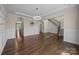 Bright living room with hardwood floors, crown molding, and an open staircase at 8614 Goodman Park Ct, Charlotte, NC 28277