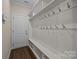 Bright mudroom with built-in storage, coat hooks, and a convenient bench, perfect for organization at 8614 Goodman Park Ct, Charlotte, NC 28277