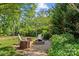 Outdoor fire pit area with stump seats and gravel at 907 Lingfield Ln, Waxhaw, NC 28173