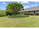Lush backyard with green lawn, mature trees, and a view of the home's exterior at 907 Lingfield Ln, Waxhaw, NC 28173