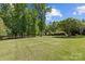 Expansive backyard with mature trees, offering privacy and ample space at 907 Lingfield Ln, Waxhaw, NC 28173
