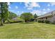 Spacious backyard featuring lush green grass, landscaping, and mature trees at 907 Lingfield Ln, Waxhaw, NC 28173