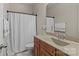 Bathroom with wood cabinets, granite counters, shower with curtain, and tile floor at 907 Lingfield Ln, Waxhaw, NC 28173