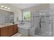 Bright bathroom features a soaking tub, glass shower, and vanity with great counter space at 907 Lingfield Ln, Waxhaw, NC 28173