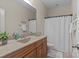 Comfortable bathroom with wood cabinets, granite counters, shower, and tile floor at 907 Lingfield Ln, Waxhaw, NC 28173