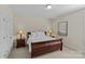 Bedroom with carpet, side tables with lamps, and a queen bed at 907 Lingfield Ln, Waxhaw, NC 28173