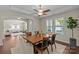 Well-lit dining room featuring hardwood floors with seamless open access to the living room for an inviting space at 907 Lingfield Ln, Waxhaw, NC 28173