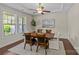 Bright dining room with hardwood floors, elegant ceiling fan, and large window for natural light and lovely decor at 907 Lingfield Ln, Waxhaw, NC 28173