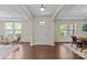 Bright foyer with gleaming hardwood floors, archways, and natural light streaming through the front door windows at 907 Lingfield Ln, Waxhaw, NC 28173