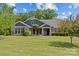 Inviting single-Gathering home featuring beautiful landscaping, well-manicured lawn, and charming architectural details at 907 Lingfield Ln, Waxhaw, NC 28173