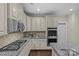 Contemporary kitchen with granite countertops, stainless appliances, and modern cabinetry at 907 Lingfield Ln, Waxhaw, NC 28173