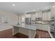 Charming kitchen with a granite island, stainless appliances, and light colored cabinets at 907 Lingfield Ln, Waxhaw, NC 28173