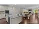 Open-concept kitchen featuring granite countertops and hardwood floors with seamless open access to the living room at 907 Lingfield Ln, Waxhaw, NC 28173