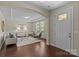 Inviting living room with an arched ceiling, hardwood floors, and a bright front door entrance at 907 Lingfield Ln, Waxhaw, NC 28173
