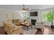 Comfortable living room with large windows, a fireplace, and neutral colored furnishings at 907 Lingfield Ln, Waxhaw, NC 28173