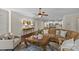 Open-concept living room with hardwood floors, a cozy seating area, and seamless access to the kitchen at 907 Lingfield Ln, Waxhaw, NC 28173