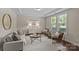 Elegant living room featuring hardwood floors, stylish furniture, and ample natural light creating a warm and inviting space at 907 Lingfield Ln, Waxhaw, NC 28173