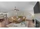 Spacious living room with hardwood floors, comfortable seating, and a cozy fireplace and an open concept layout at 907 Lingfield Ln, Waxhaw, NC 28173