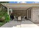 Covered brick patio with a dining table and chairs, ideal for outdoor relaxation at 907 Lingfield Ln, Waxhaw, NC 28173