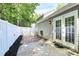 Backyard patio featuring a privacy fence, brick pavers, and landscaped garden beds at 9212 Scotts Elm Ct, Charlotte, NC 28215