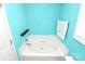 Bright bathroom features a white soaking tub with white tile surround and a modern faucet, exuding a spa-like feel at 9212 Scotts Elm Ct, Charlotte, NC 28215