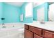 Bright bathroom with a bathtub, white toilet, and neutral colors at 9212 Scotts Elm Ct, Charlotte, NC 28215