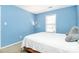 Bright bedroom with soft natural light, a cozy bed, and neutral decor creating a peaceful retreat at 9212 Scotts Elm Ct, Charlotte, NC 28215