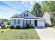 Charming single-story home with a well-manicured lawn and attached one car garage at 9212 Scotts Elm Ct, Charlotte, NC 28215