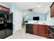 Functional kitchen with wood cabinets and black appliances that opens to living space at 9212 Scotts Elm Ct, Charlotte, NC 28215