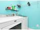 Bright laundry room with modern Maytag washer and dryer, and convenient shelving at 9212 Scotts Elm Ct, Charlotte, NC 28215