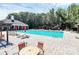 Community pool with lounge chairs and umbrellas on a sunny day at 9212 Scotts Elm Ct, Charlotte, NC 28215