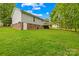 Large grassy backyard featuring a wooden deck, perfect for outdoor entertaining and relaxation at 1013 E Academy St, Cherryville, NC 28021