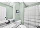 Fresh bathroom with granite countertop sink, updated fixtures, and shower with curtain at 1013 E Academy St, Cherryville, NC 28021