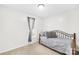 Simple bedroom with a gray bed and light-filled window at 1013 E Academy St, Cherryville, NC 28021