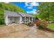 Inviting single-story home with a covered carport, front porch, and vibrant rose bushes at 1013 E Academy St, Cherryville, NC 28021