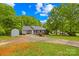 Well-maintained home with an outbuilding, spacious driveway, and manicured lawn at 1013 E Academy St, Cherryville, NC 28021