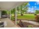 Relaxing covered front porch with a swing and views of the landscaped yard at 1013 E Academy St, Cherryville, NC 28021